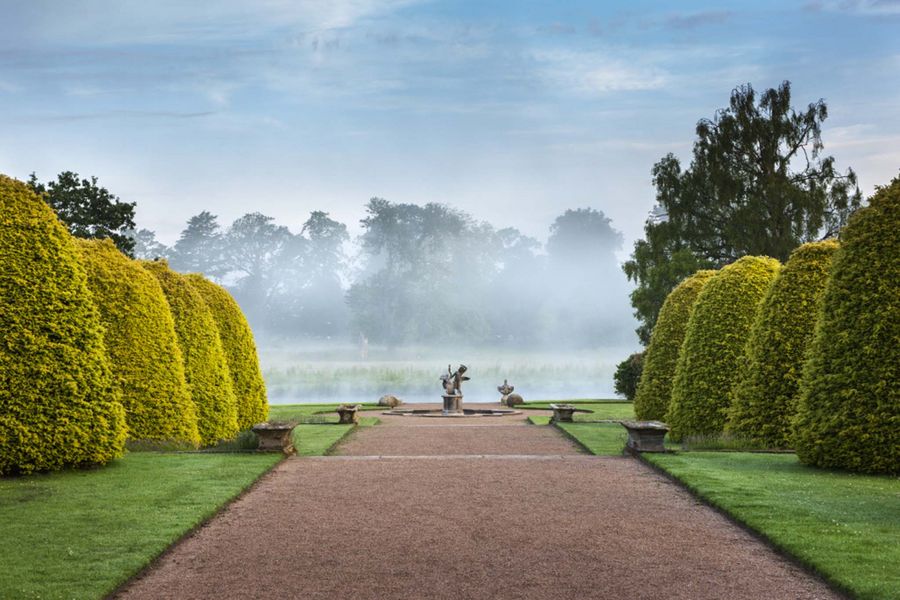 The garden terraces in June on a misty morning on the Shugborough Estate, Staffordshire.