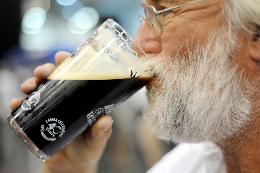 A man drinks real ale during the first day of the Campaign For Real Ale (CAMRA) Great British Beer Festival at Earl's Court, London.